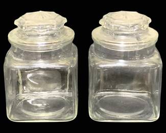 2015 - 2 Glass Canisters 7" (Description): A set of two glass canisters with matching  lids. Each canister measures 7 inches in  height.
