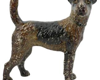 86 - Cast Iron Dog Figure 8.5" (Description): Cast iron dog figure depicting a terrier in a  standing pose with tail raised. The figure  features a cold-painted finish in brown and  black tones with some wear consistent with  age. Measures 8.5 inches.