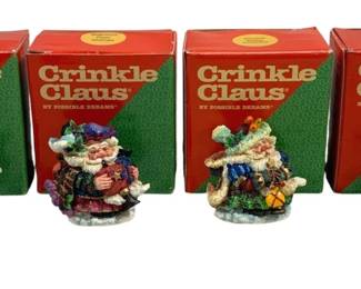 2082 - 4 Crinkle Claus Ornaments in Boxes (Description): Four Crinkle Claus figures by Possible  Dreams, each in its original box. These  collectible Santa Claus figurines feature the  distinctive crinkled style characteristic of  the Crinkle Claus line.