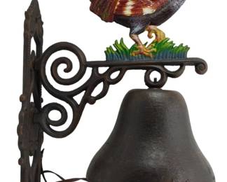 187 - Cast Iron Rooster Bell 24"x13"x9" (Description): Cast iron rooster bell featuring a colorfully  painted rooster figure perched atop a  decorative scrollwork bracket. The rooster  displays vibrant hand-painted details with a  blue tail, brown and white body plumage, yellow breast, and red comb and wattle. The  bracket features ornate curling ironwork  designs and mounts to a wall via a decorative  backplate. A traditional cast iron bell  hangs below with an attached pull cord.