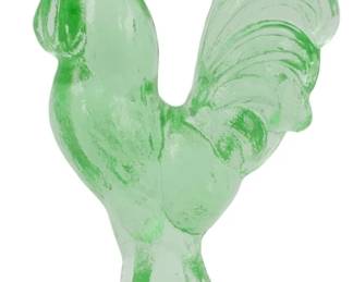 134 - Green Glass Rooster Figure 4.5" (Description): Green glass rooster figure featuring a proud  stance with detailed tail feathers and an  upright comb. The translucent green glass has  a charming vintage quality reminiscent of  Depression-era glassware. Measures 4.5 inches.