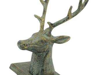 126 - Cast Iron Deer Shelf Hanger (Description): Cast iron deer head shelf hanger featuring a  stag with detailed antlers mounted on a  rectangular base with a curved hook. Measures  8" x 5" x 5.5".