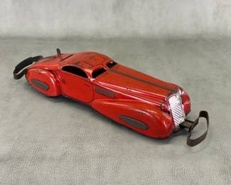 A vintage 1930s Marx red lithographed Streamline "Reversible Coupe" tin wind-up bumper car, also known as the "Marvel Car"