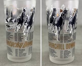 1960 Kentucky Derby glass, frosted/gray glass featuring the iconic Churchill Downs twin spires, racing horses in black and white, gold lettering, and a historical list of past Derby winners. 
