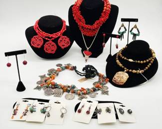 Stunning necklace of multi-strand red glass beads with three circular carved cinnabar openwork dragon plaque pendants, 12 inches length; another show stopper featuring layered branch coral segments paired with round read beads near the clasp, 16” long; a polished tigers-eye beaded pendant necklace with a carved hardstone openwork pendant combining a butterfly and floral sprays; and a great boho-chic vintage Moroccan Berber necklace, 21-¼” long, of natural stone, glass, and branch coral beads mixed with protective amulets, old Moroccan coins, and geometric Berber filigree cross charms. 