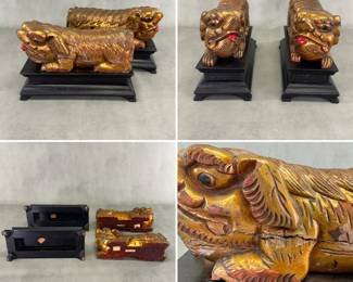 More views of the pair of carved and lacquered gilt wood fo dogs or lions, on black lacquered wooden bases, each  made in China. Each is 4-1/2"W x 7"H x 10-3/4"L.