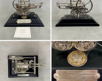 More views of the 200th anniversary commemorative model of Richard Trevithick's Steam Locomotive and an enclosed uncirculated 2004 uncirculated two pound coin issued by Royal Mint; comes with certificates of authenticity. 