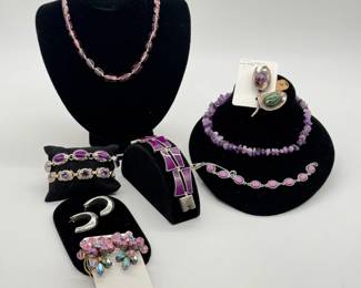 A vintage sterling silver link bracelet set with vibrant purple inlay stones, crafted in a modernist or Art Deco style; pink art glass beaded necklace; vintage pair of Aurora Borealis bead cluster earrings, sterling silver J-hoop earrings; Los Castillo Mexican silver and amethyst brooch