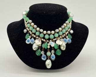 A lovely 1950s French necklace, 14" length, with a bib/collar silhouette of complex, layered strands molded opaque green jadeite-style glass beads, faux pearls, smooth round roundels, and distinct opalescent teardrop/leaf glass charms that exhibit an iridescent blue-white flash