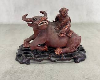 Antique Chinese finely carved wooden sculpture of boy riding a water buffalo; with original custom carved wooden stand.  10" long by 7-1/2" high.