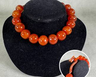 A marvelous chunky round bead necklace featuring large, warm orange-red carnelian or red agate beads, with carved dragon head hook closure. 15" length.