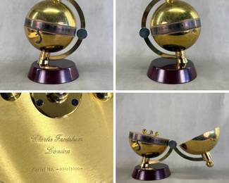 More views of the vintage limited edition Charles Frodsham brass globe desk clock, with engraved world map and a unique silvered time-indicator shaped like a fish tail, edition number 0310/5000 engraved on the central winding plate. Created exclusively for The Heritage Collection, comes with the original certificate of authenticity, and letter with globe clock care recommendations from Charles Frodsham & Co Ltd.