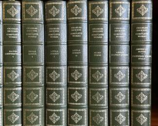 Charles Dickens: The Complete Works Centennial Edition 29-volume set, green faux-leather with ornate gold gilt lettering, decorative spine and board tooling, and a built-in ribbon bookmark; published around 1970 by Heron Books