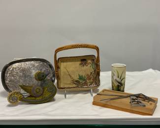 Vintage silver plated oval tray, a vintage square Japanese ceramic or porcelain serving tray or bowl with a hand-painted floral and gold-accented botanical design and an arched woven rattan or bamboo handle; a vintage porcelain cylindrical vase with hand-painted heron; Rakushisha geometric stainless steel scissors from Kyoto, Japan, resting inside a custom-made wooden display/storage box