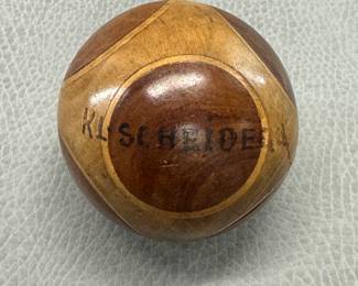 An antique Swiss turned and segmented wooden souvenir ball, crafted with contrasting woods and inlaid geometric patterns, stamped with "KL Scheidegg" (a mountain pass in Switzerland.)