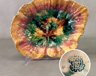 The second of two leaf-shape ceramic  majolica dishes from Griffen, Smith & Hill of Phoenixville, Pennsylvania, late 19th century, with impressed company marks – one with the entwined initials logo, one with the logo inside a round imprint reading “Etruscan Majolica.” Each dish is 8-3/4” long x 6-3/4” wide x 2” high. 