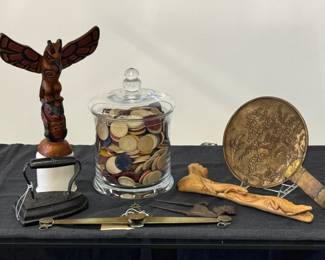 A Canadian hand-carved and hand-painted wooden totem pole featuring a Thunderbird & Killer Whale Totem Pole design; a large, clear glass apothecary or canister jar with a matching glass lid, filled with vintage-style round gaming counters or clay-composite poker chips; an antique betel nut cutter from Bali, Indonesia; an antique brass equal-arm balance scale beam, manufactured by the historical maker S. Lewis of New York; Antique Japanese hand mirror of patinated bronze, Meiji period (1868-1912), the detailed non-reflecting part is decorated in relief with an aquatic landscape.