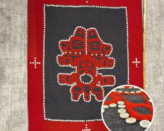 Northwest Coast button blanket circa 1930s-40s, Tlingit peoples, depicting a “splayed” or split representation of an animal for a clan’s crest; made of trade wool, felt, shell buttons; 44 inches tall by 35 inches wide.