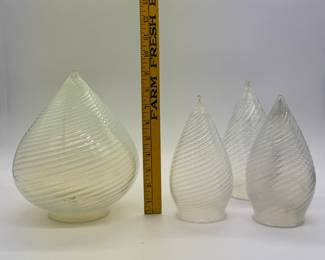 A set of vintage opalescent optic swirl glass teardrop (or bullet) light shades, including a larger shade (roughly 9 inches tall) and three smaller matching shades approximately 7-3/4” tall