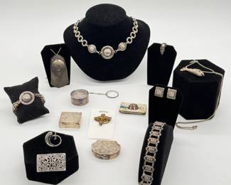 A demi-parure of vintage-style silver-tone statement necklace featuring three circular medallions linked by patterned chain links, with matching bracelet; a silver-toned filigree and marcasite bracelet, a vintage silver-tone articulated fish pendant necklace