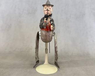 A vintage/antique tin lithograph clockwork wind-up figure (a clown or possibly Charlie Chaplin as The Little Tramp?), 9-1/4" tall