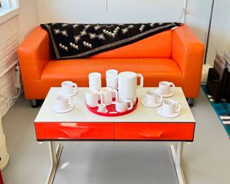 A Raymond Loewy DF2000 two-drawer mini-credenza console table (or stereo/tv table!), from the “DF2000” collection designed by legendary industrial designer Raymond Loewy and produced by Doubinsky Freres, 1968; the drawer fronts moulded from vivid red Metacrylene set in a frame of off-white plastic and rosewood veneer supported by moulded lacquered white aluminum