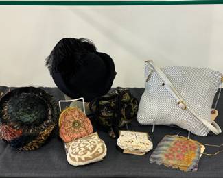 A vintage women's pheasant feather hat (often styled as a pillbox, skullcap, or cocktail hat) from the 1950s or 1960s; a Longchamps beaded purse, made in France; small vintage floral mesh evening purse with gold-tone frame and chain handle; a Whiting & Davis metal mesh shoulder bag with leather strap; a vintage or Victorian-style pink satin or silk purse adorned with green and cream floral embroidery and an ornate gold-tone metal frame and clasp, with chain handle