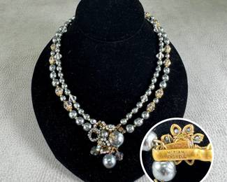 A mid-century signed Miriam Haskell costume jewelry necklace – double-strand grey baroque faux pearls accented with clear faceted crystal spacer beads, intricate gold-tone metal spacer caps, and a signature ornate focal cluster of larger beads, seed beads, and rhinestones.