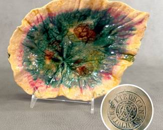 One of two leaf-shape ceramic  majolica dishes from Griffen, Smith & Hill of Phoenixville, Pennsylvania, late 19th century, with impressed company marks – one with the entwined initials logo, one with the logo inside a round imprint reading “Etruscan Majolica.” Each dish is 8-3/4” long x 6-3/4” wide x 2” high. 