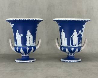 A pair of antique large Wedgwood dark blue dip jasperware double-handled urn shaped vases, 10"H, adorned with finely modeled neoclassical applied sprig decoration. Impressed 'WEDGWOOD' mark on the base.
