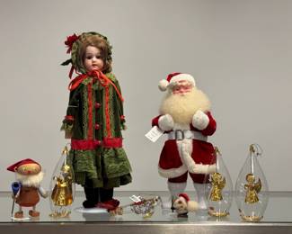 A 17" Simon & Halbig bisque head shoulder doll wearing holiday green and red dress and hat; three vintage Resl Lenz "Angel" diorama Christmas ornaments from West Germany, teardrop-shaped, mouthblown clear glass container holding handcrafted three-dimensional gold foil angel figures, the bottom with gold foil spinner base