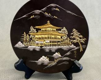 A vintage Japanese Amita damascene ware display plate, 5-3/4"W, featuring the iconic Kinkaku-ji (The Golden Pavilion) temple in Kyoto and signed by artist Tetsuzoh Shoji. The metal plate is meticulously inlaid with 24K gold, green gold, and pure silver, and comes with original purchase and guarantee paperwork from Amita Corp., Kyoto Handi Craft Center in 1988.