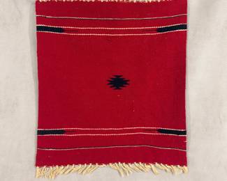A vintage Chimayo New Mexio Southwest woven textile, red, featuring characteristic horizontal band layouts framing a small central geometric design, and fringed edges, 19-3/4" x 19-3/4"
