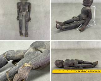An Asian antique wooden articulated devotional figure or temple sculpture with pegged joints allowing the arms and legs to move; 12 inches long.