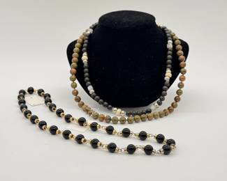 Vintage black onyx bead and gold-tone spacer necklace, a polished Unakite gemstone bead necklace with 14k gold clasp, and a beaded necklace featuring a mix of dark wood or black spherical beads, natural/cream-toned wooden or bone beads, and textured silver- or metal-toned spacers