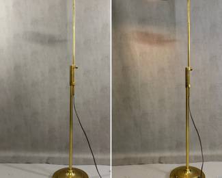 A mid-century brass adjustable floor lamp