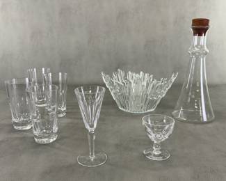 A Revontulet (Northern Lights) Ice Glass Bowl designed by Tauno Wirkkala for Humppila Lasi (Humppila) in Finland during the 1960s to 1970; a mid-century modern Dansk Wine Carafe designed by Gunnar Cyrén featuring a clear flared glass body and a distinctive teak wood stopper; glass tumbers and wine glass