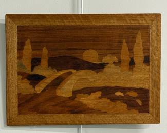 A vintage rectangular wood marquetry wall art piece featuring a landscape with a curved bridge, trees, and setting sun.  11-5/8"W x 16"H.