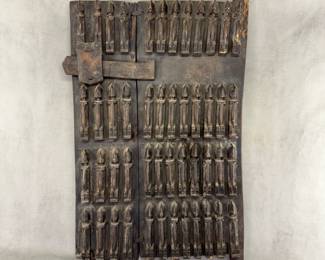 A traditional Dogon Granary Door (or shutter) from Mali, West Africa, dating from the 19th to mid-20th century. 17.75"W x 29.75H. Carved from dark hardwood, these doors historically sealed small openings to family food storehouses and featured a sliding wooden lock mechanism.