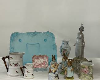 Vintage Beatrix Potter figurines Cottontail, Peter Rabbit, Mrs. Flopsy Bunny, and Cecily Parsley, by Beswick England; Lladro Talk of the Town figurine model #01005788; a vintage Royal Crown Derby Red Aves porcelain trinket tray, hand-painted ceramic barrel-shape pitcher and creamer