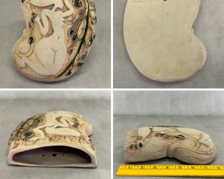 A ceramic studio pottery wall vase featuring an embossed, low-relief female figure, with glazed floral and botanical details; 8 inches high.