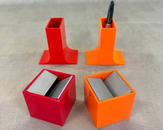 Mid-century modern accessories in red and orange: vintage Cubo ashtrays designed by Bruno Munari in 1957 for Danese Milano, and Lampedusa pencil holders designed by Enzo Mari for Danese Milano in 1967