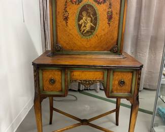 A 1930s vintage Sheraton-revival secretary desk (a drop-front or fall-front style) manufactured by Scholle's Furniture Co. of Chicago, featuring cherub marquetry design, surrounded by delicate floral inlays and a bow-and-garland motif