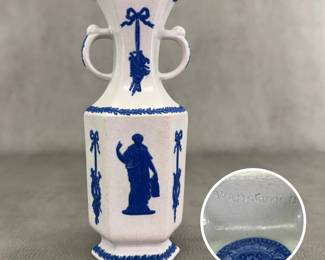  rare antique c. 1820 Wedgwood white jasper two-handled vase with waxen sheen finish and applied blue sprig classical Greek figures and both arts and military symbols decoration. Stamped Wedgwood to the base – each letter individually stamped in —and a blue sprig oval embossed "pad mark" showing the numerals 979 for the shape number. 8"H x 3"W.