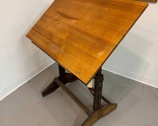 A mid-century vintage adjustable wood and metal drafting table