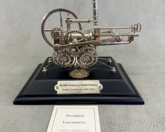 A 200th anniversary commemorative model of Richard Trevithick's Steam Locomotive and an enclosed uncirculated 2004 uncirculated two pound coin issued by Royal Mint; comes with certificates of authenticity. 