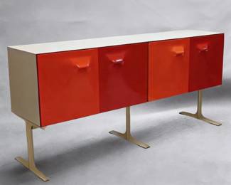 A Raymond Loewy DF2000 two-sided room divider cabinet, by Raymond Loewy for Doubinsky Freres, 1968; a marvelous two-sided, eight door buffet or room divider from the ‘DF2000’ collection, with eight doors situated on two sides, the fronts moulded from vivid red Metacrylene set in a frame of off-white plastic supported by moulded aluminum lacquered white.