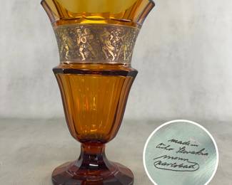 A beautiful signed amber facet-cut glass Moser Karlsbad frieze vase, 11" high with an acid-etched “Oroplastic” gold-gilt frieze of Amazon warriors and Greek soldiers. The underside signed in script, ‘Moser, Carlsbad, made in Czechoslovakia’. Circa 1925.