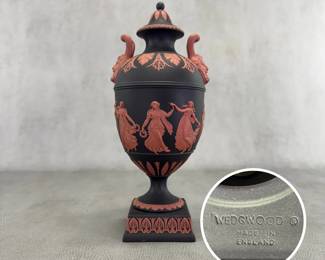 A marvelous Wedgwood black basalt 'Dancing Hours' lidded urn, 10-1/2"H, with applied terracotta relief and Bacchus head handles. Exquisitely fine modeling on this museum quality piece!