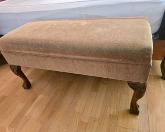 vintage upholstered storage bench with carved cabriole legs and claw feet